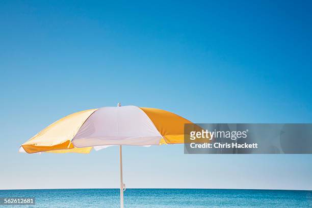 usa, massachusetts, nantucket, beach umbrella by sea - beach umbrella stock pictures, royalty-free photos & images
