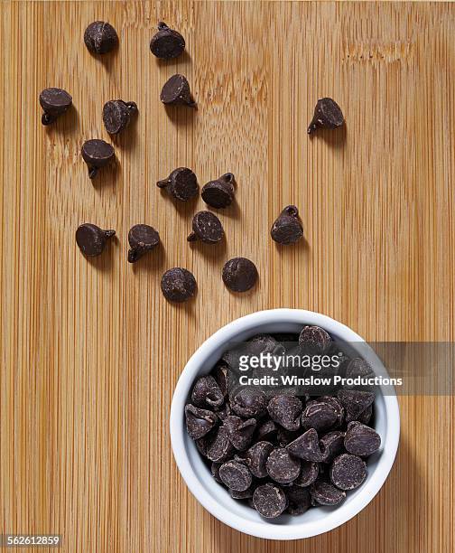 stack of chocolate chips in ramekin - chocolate chip stock-fotos und bilder