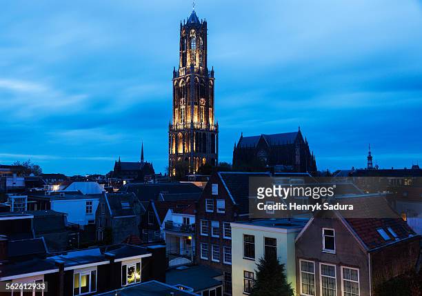netherlands, utrecht, dom tower of utrecht, view of illuminated tower in city - utrecht stockfoto's en -beelden