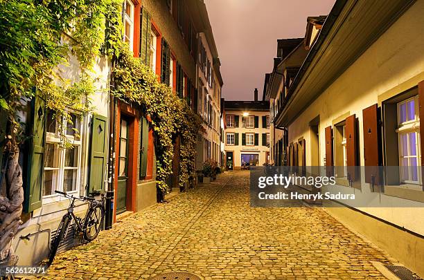 switzerland, basel-stadt, basel, view along illuminated old town street - basel switzerland stockfoto's en -beelden