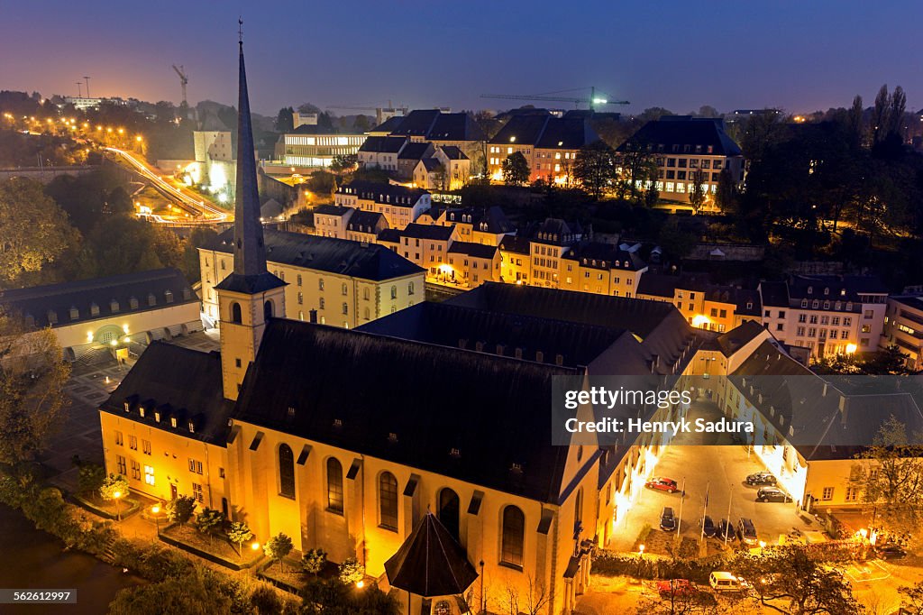 Luxembourg, Luxembourg City, Neumunster Abbey, Illuminated church and surrounding cityscape