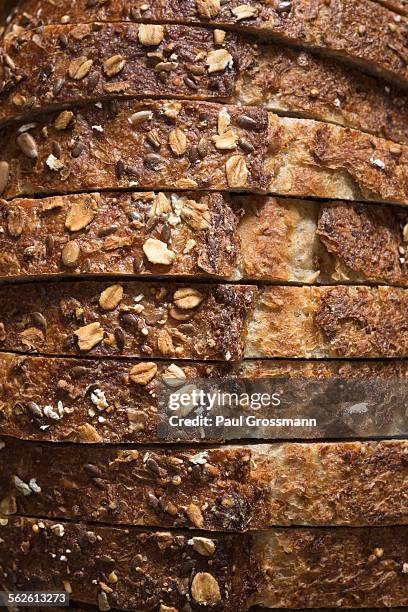 close-up of sliced whole grain oat bread - wholemeal bread stock pictures, royalty-free photos & images