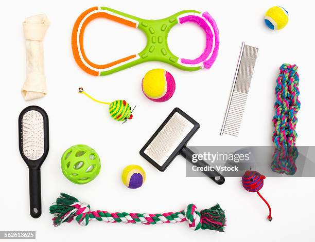 collage of pet toys and combs on white background - dog's toy stockfoto's en -beelden