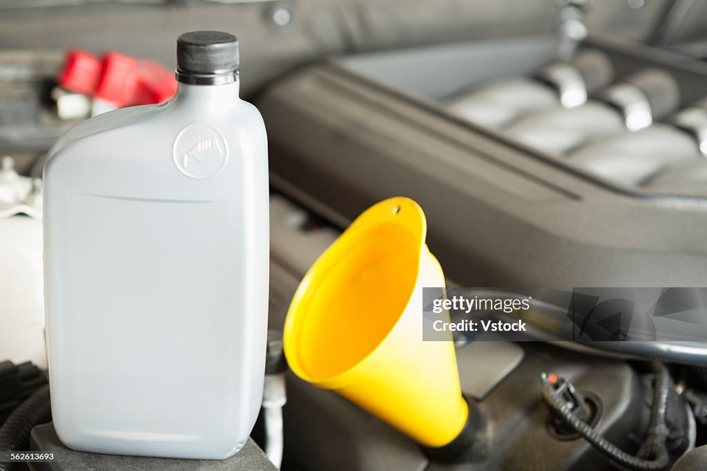 Plastic oil bottle on car