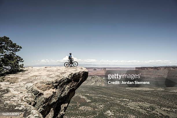 biking near moab utah. - edge of a cliff stock pictures, royalty-free photos & images