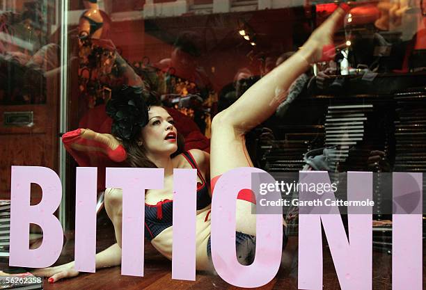 Model wearing underwear by luxury lingerie brand Agent Provocateur performs in a live window display to mark tomorrow's publication of new book...