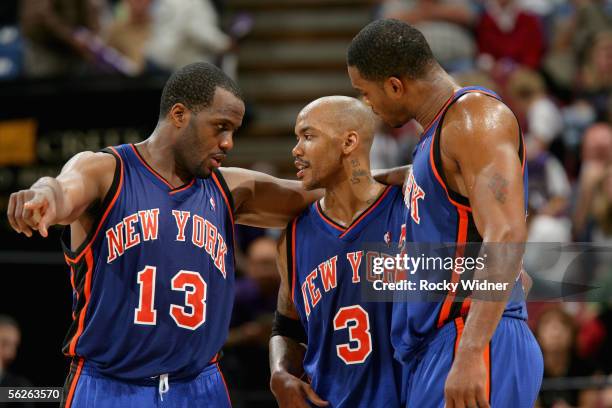 Malik Rose, Stephon Marbury and Antonio Davis of the New York Knicks huddle together during a break in the game against the Sacramento Kings at Arco...