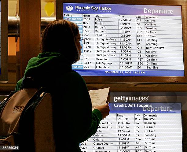 Passengers checks the departure monitors in Terminal 4 at Sky Harbor International Airport November 23, 2005 in Phoenix, Arizona. More than 150,000...