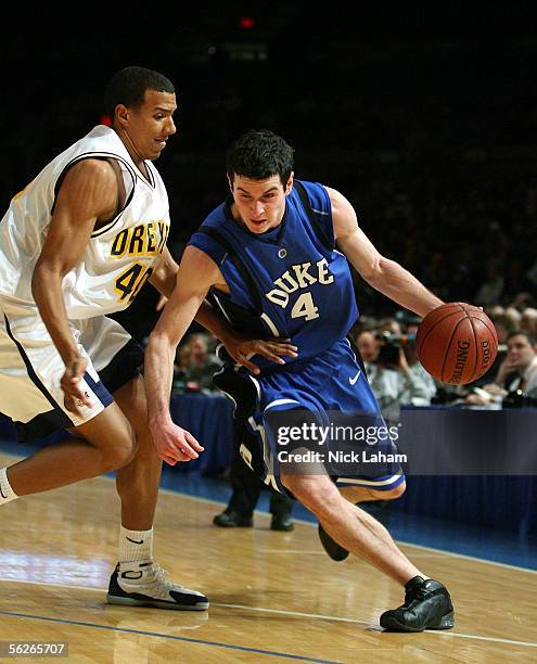 Redick of the Duke Blue Devils drives to the hoop around Kenny Tribbett of the Drexel Dragons during their Preseason NIT game at Madison Square...