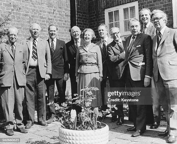 Conservative Party leader Margaret Thatcher posing with the politicians who will make up her cabinet if they win the upcoming General Election; Angus...