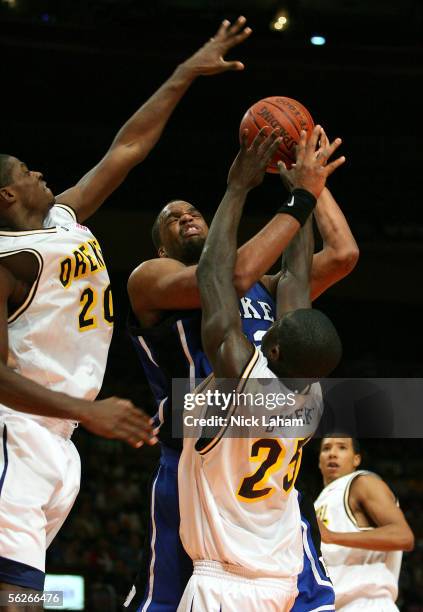 Shelden Williams of the Duke Blue Devils fights to put up a shot over Randy Oveneke and Chaz Crawford of the Drexel Dragons during their Preseason...