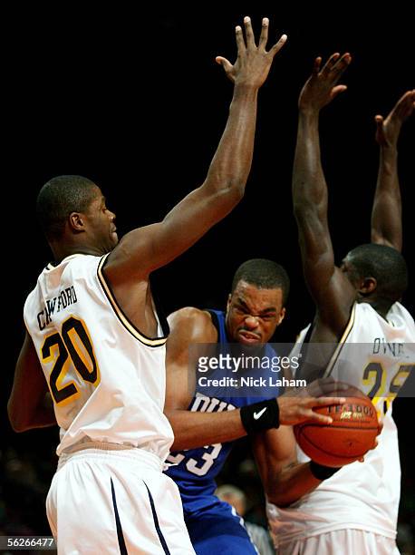 Shelden Williams of the Duke Blue Devils fights to put up a shot over Randy Oveneke and Chaz Crawford of the Drexel Dragons during their Preseason...