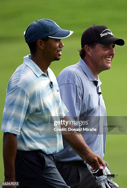 Phil Mickelson smiles with Tiger Woods during the final round of the 23rd PGA Grand Slam of Golf on November 23, 2005 at Poipu Bay Golf Course in...