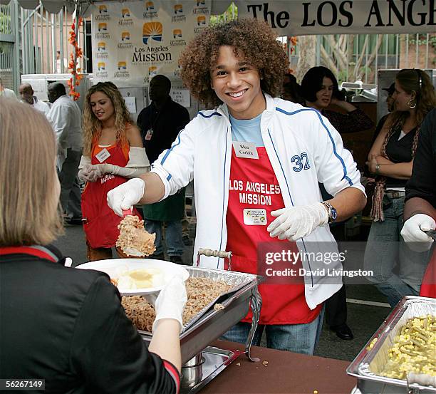 Actor Corbin Bleu poses while serving to a volunteer at the Los Angeles Mission and Anne Douglas Center's Thanksgiving Meal for the Homeless on...