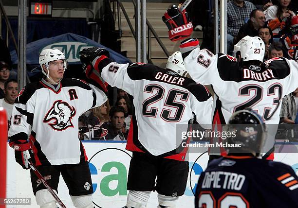 Leftwing Jochen Hecht of the Buffalo Sabres celebrates with teammates Mike Grier and Chris Drury after scoring against goaltender Rick DiPietro of...