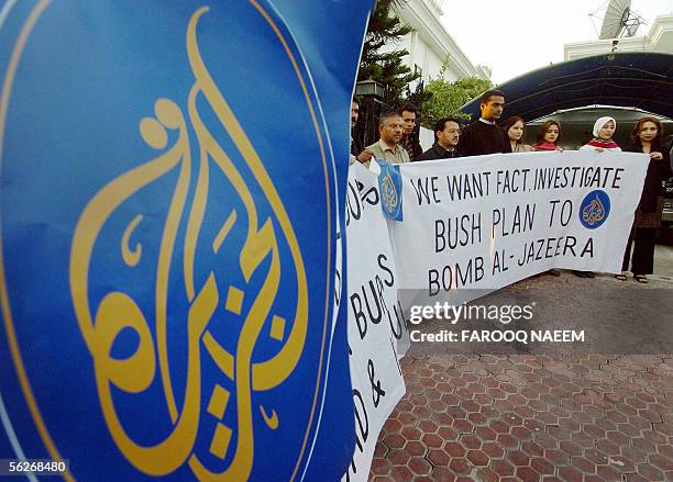 Employees of Qatar-based satellite channel Al Jazeera television hold banners and a placard during a demonstration in Islamabad, 24 November 2005....