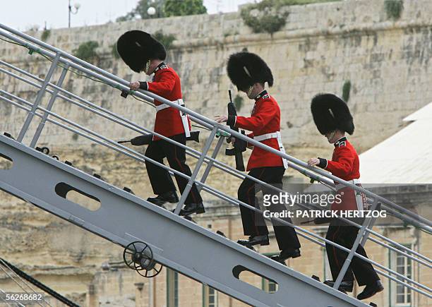 British Grenadier guards walk up the gangway of the British Royal Navy aircraft carrier "HMS Illustrius" during Queen Elizabeth II's visit, 24...