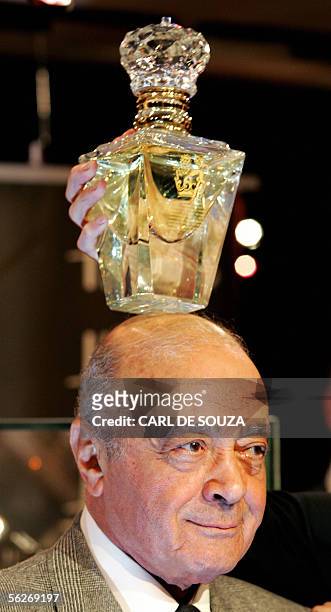 London, UNITED KINGDOM: The most expensive available bottle of perfume called Imperial Majesty made by the Roja Dove Haute Parfumerie is held above...