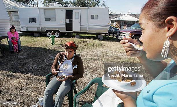 Blanchard family members eat a Thanksgiving meal of gumbo outside the trailers they are living in November 24, 2005 in New Orleans. Sixteen Blanchard...