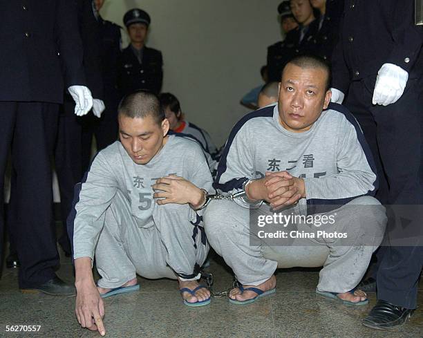 Police escorts criminals convicted of abducting and selling children during sentencing on November 24, 2005 in Dongguan of Guangdong Province, China....