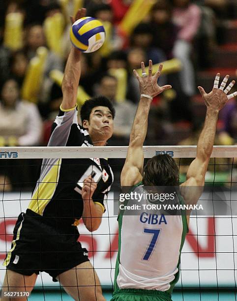 Masaji Ogino of Japan spikes the ball against Gilberto Godoy Filho of Brazil during their 2005 World Grand Champion Cup men's volleyball match in...