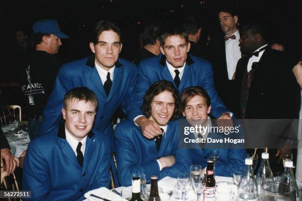 English boy band Take That wearing matching blue teddy boy suits at the Brit Awards, where they performed a medley of Beatles songs, 1994. From left...