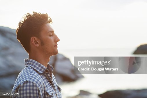 Profile of man on rocky beach Profile of man on rocky beach