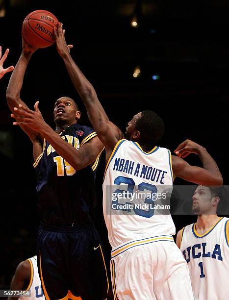 Frank Elegar of the Drexel Dragons puts up a shot over Luc Richard Mbah a Moute of the UCLA Bruins during their Preseason NIT Tournament game at...