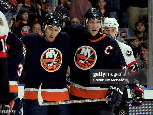 Alexei Yashin of the New York Islanders celebrates his first period goal against the Ottawa Senators with teammate Miroslav Satan on November 25,...