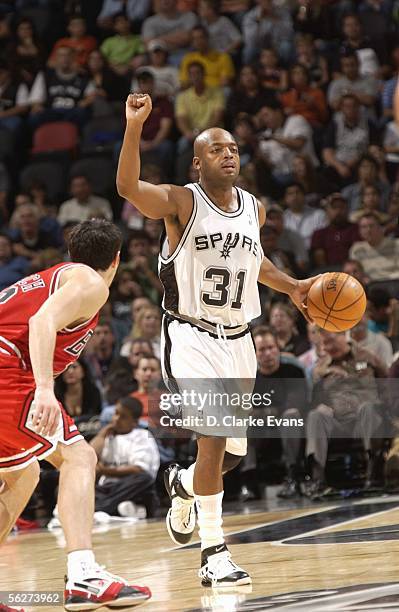 Nick Van Exel of the San Antonio Spurs drive the ball up court against Kirk Hinrich of the Chicago Bulls at the SBC Center on November 25, 2005 in...