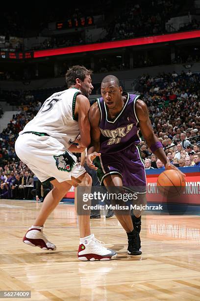 Bobby Simmons of the Milwaukee Bucks drives to the basket around Marko Jaric of the Minnesota Timberwolves on November 25, 2005 at the Target Center...