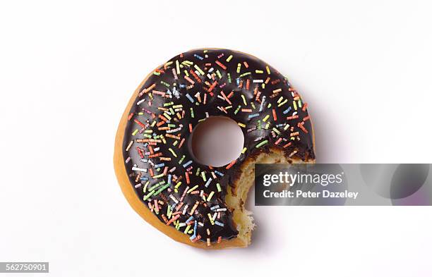 bite out of doughnut - doughnuts stockfoto's en -beelden