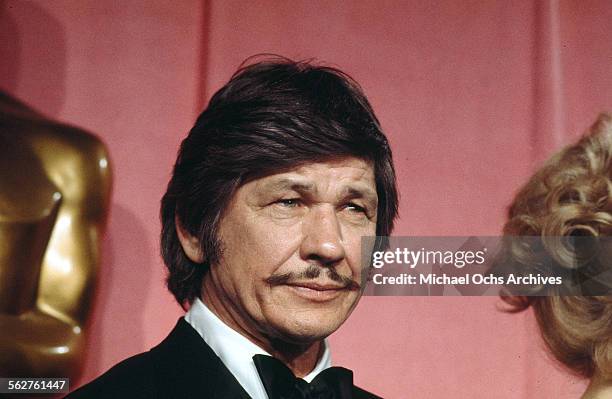 Actor Charles Bronson poses backstage after presenting "Best Supporting Actress" award during the 46th Academy Awards at Dorothy Chandler Pavilion in...