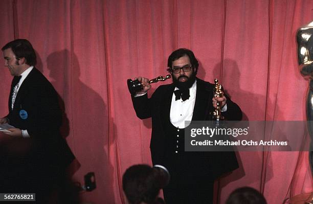 Director Francis Ford Coppola pose backstage with his Oscar after winning "Best Director" and "Best Picture" award during the 47th Academy Awards at...