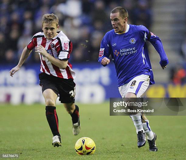 Iain Hume of Leicester goes past Leigh Bromby of Sheffield during the Coca-Cola Championship match between Leicester City and Sheffield United at the...