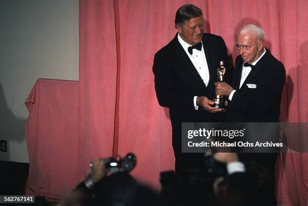 Actor John Wayne and Director Howard Hawks, Academy Honorary Award winner pose backstage during the 47th Academy Awards at Dorothy Chandler Pavilion...