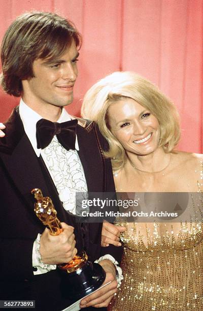 Actor Keith Carradine poses backstage after winning "Best Original Song" with actress Angie Dickinson during the 48th Academy Awards at Dorothy...