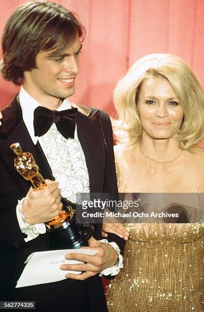 Actor Keith Carradine poses backstage after winning "Best Original Song" with actress Angie Dickinson during the 48th Academy Awards at Dorothy...