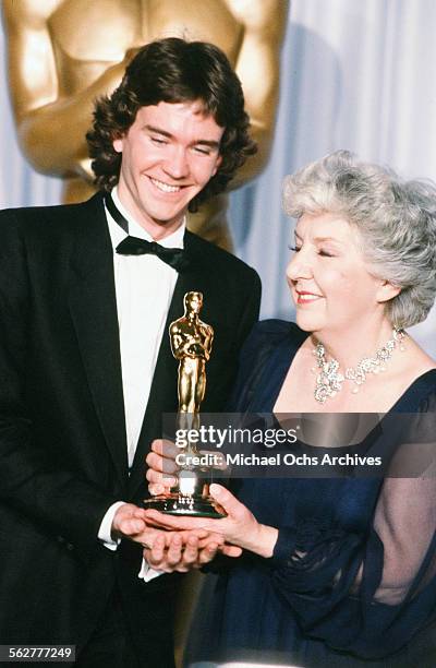 Actor Timothy Hutton and actress Maureen Stapleton pose backstage after winning "Best Supporting Actress" during the 54th Academy Awards at Dorothy...