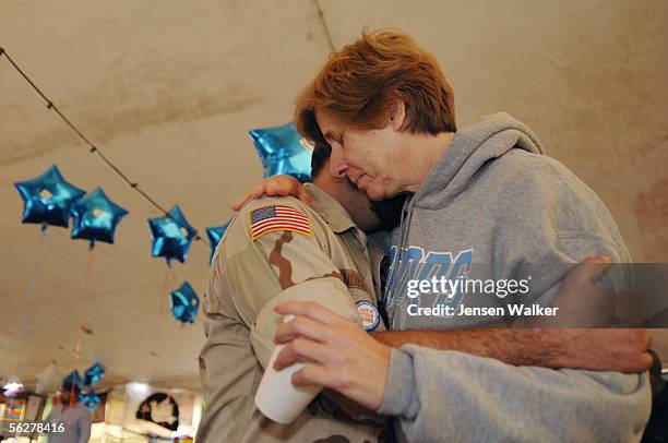 Cindy Sheehan hugs Gulf War veteran Charles Anderson in the Camp Casey tent on November 26, 2005 in Crawford, Texas. Cindy Sheehan, supported by the...