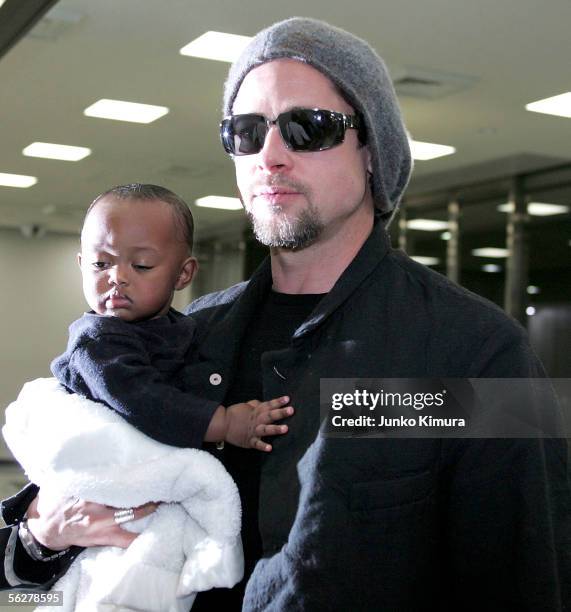 Actor Brad Pitt holds Zahara Marley Jolie as they arrive at the New Tokyo International Airport on November 27, 2005 in Narita, Japan. They are in...