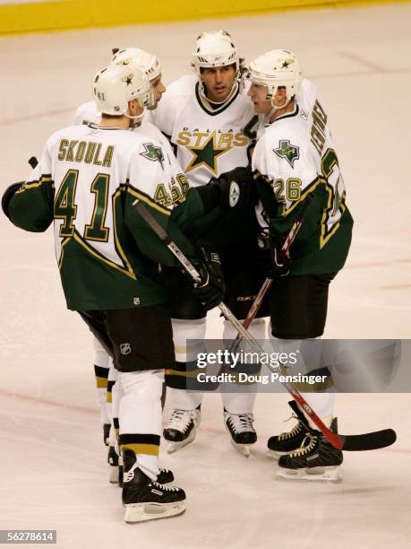 Jere Lehtinen of the Dallas Stars is congratulated for his second period goal by teammates Mike Modano, Sergei Zubov and Martin Skoula as the...