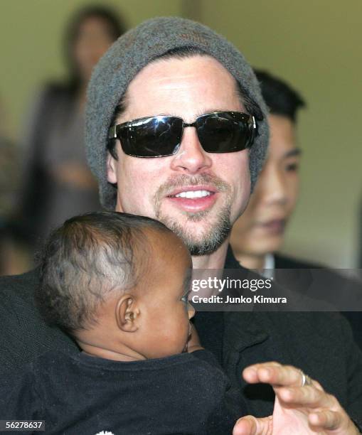 Actor Brad Pitt holds Zahara Marley Jolie as they arrive at the New Tokyo International Airport on November 27, 2005 in Narita, Japan. They are in...