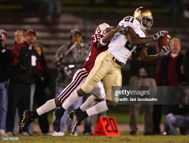 Maurcie Stovall of Notre Dame catches a pass over T.J. Rushing of Stanford during a game at Stanford University on November 26, 2005 in Stanford...