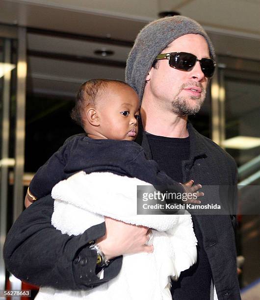 Actor Brad Pitt holds Zahara Marley Jolie as they arrive at the New Tokyo International Airport on November 27, 2005 in Narita, Japan. Pitt and...
