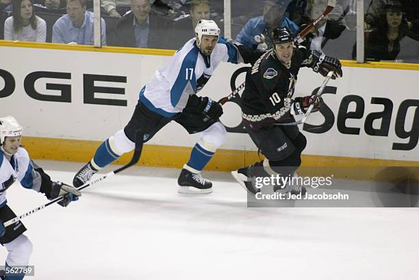 Scott Thornton of the San Jose Sharks challenges Denis Pederson of the Phoenix Coyotes during game one of their first round Stanley Cup playoff...