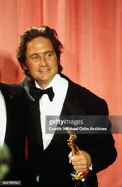 Producers Michael Douglas poses backstage after winning the "Best Picture" award for "One Flew Over the Cuckoo's Nest" during the 48th Academy Awards...