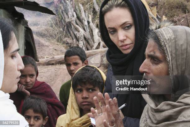 In this handout photo supplied by the United Nations High Commission for Refugees , UNHCR Goodwill Ambassador Angelina Jolie listens as a local woman...