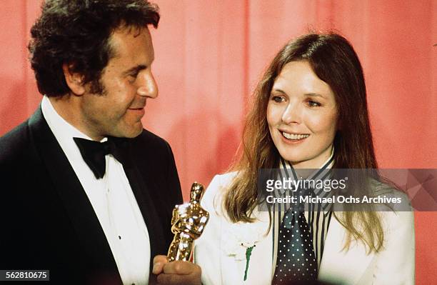 Director Milos Forman pose backstage after winning "Best Director" for "One Flew Over the Cuckoo's Nest" with actress Diane Keaton during the 48th...