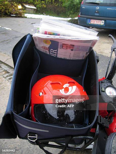 Belgian postman' helmet pictured 28 November 2005 in Wavre. The ever-efficient Belgian postal service wants to know how long it takes mailmen and...